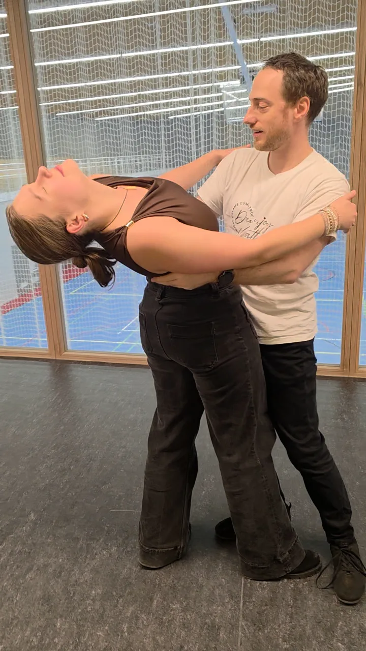 A follower in a deep back bend with her partner
