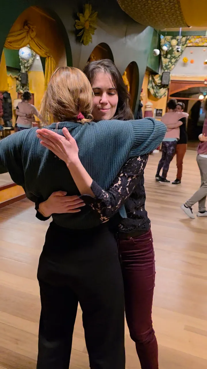 Two dancers hugging on the dance floor