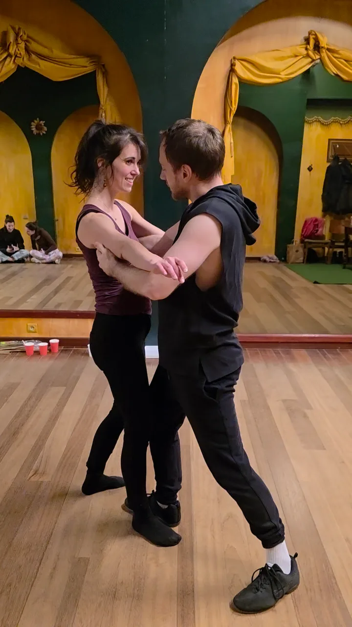 A couple dancing in a studio with yellow walls