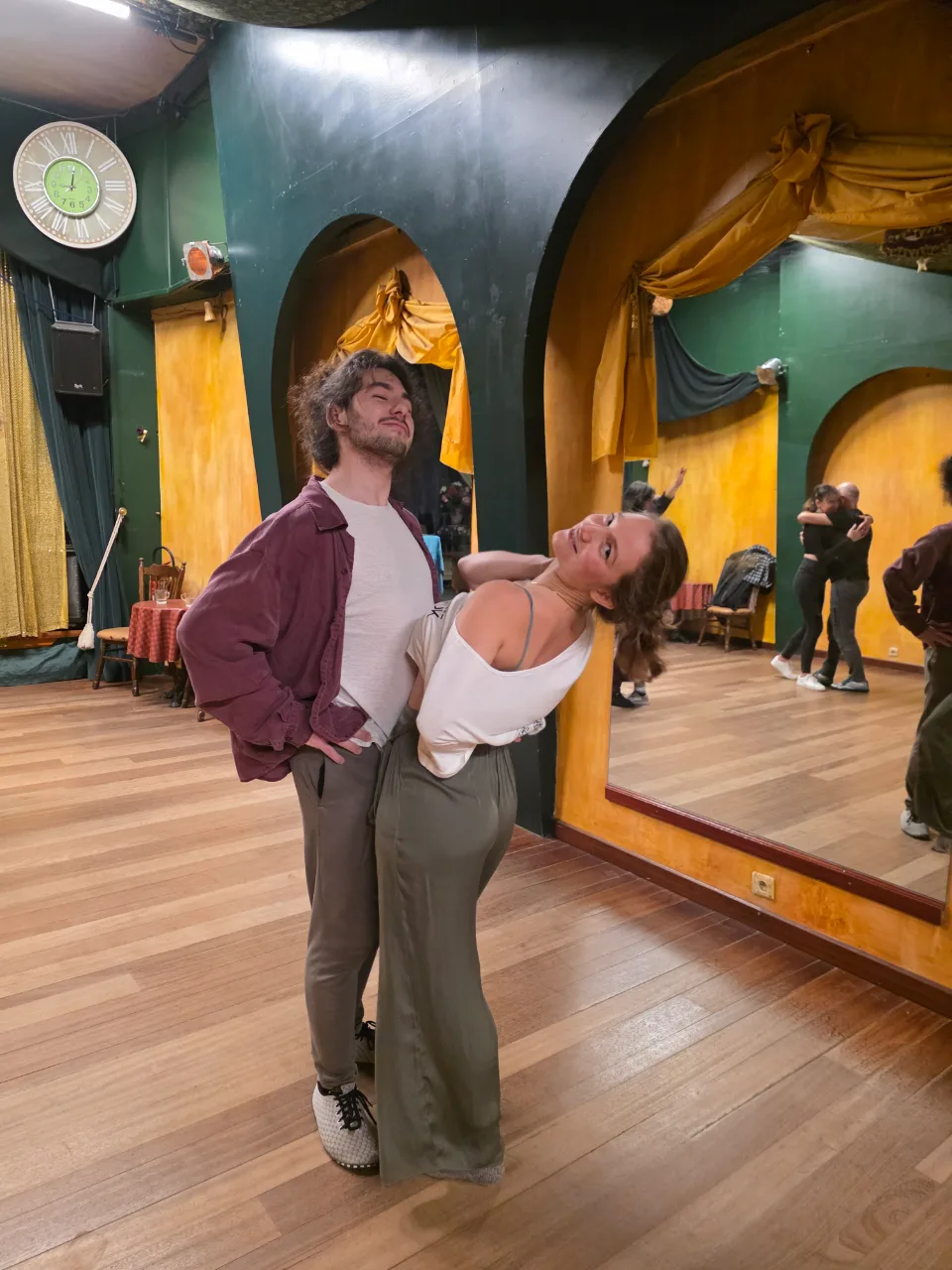 A couple in a playful lean in the studio