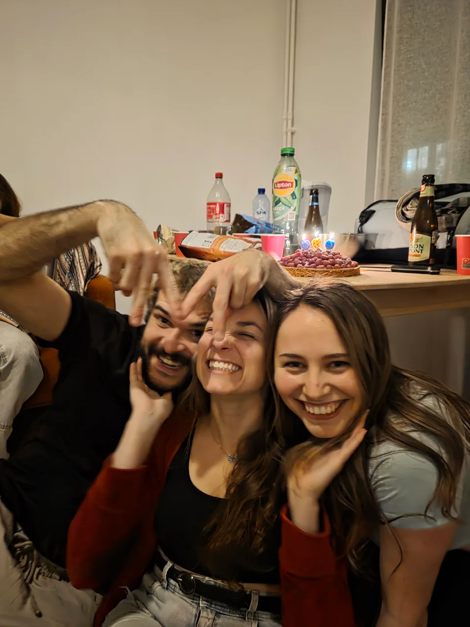Three friends smiling for a selfie