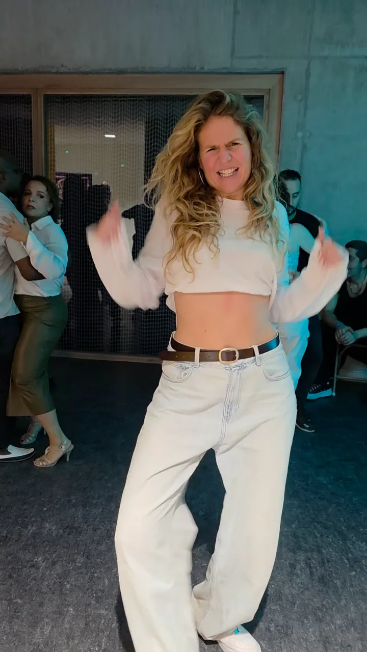 A dancer laughing mid-move