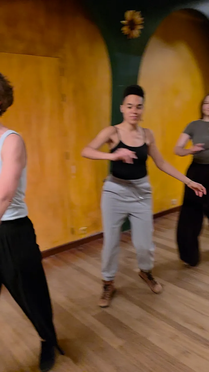 Dancers practising in a yellow studio