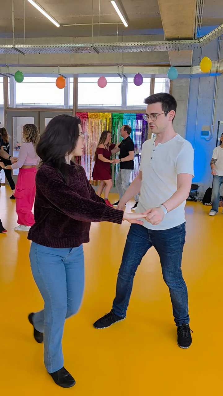 A couple dancing on a yellow floor